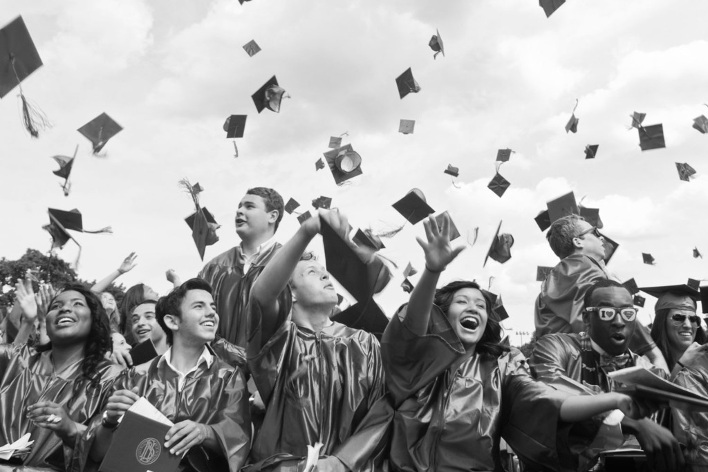 Students at graduation throwing caps up in the air, Black and White Photo