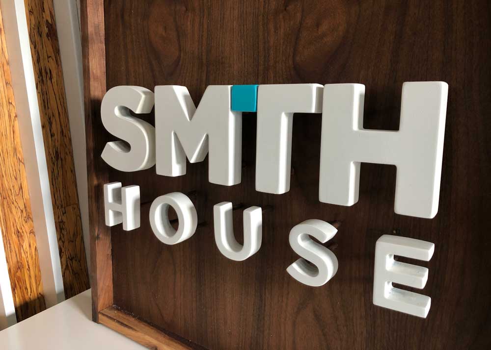 Smith House Design logo on wood background